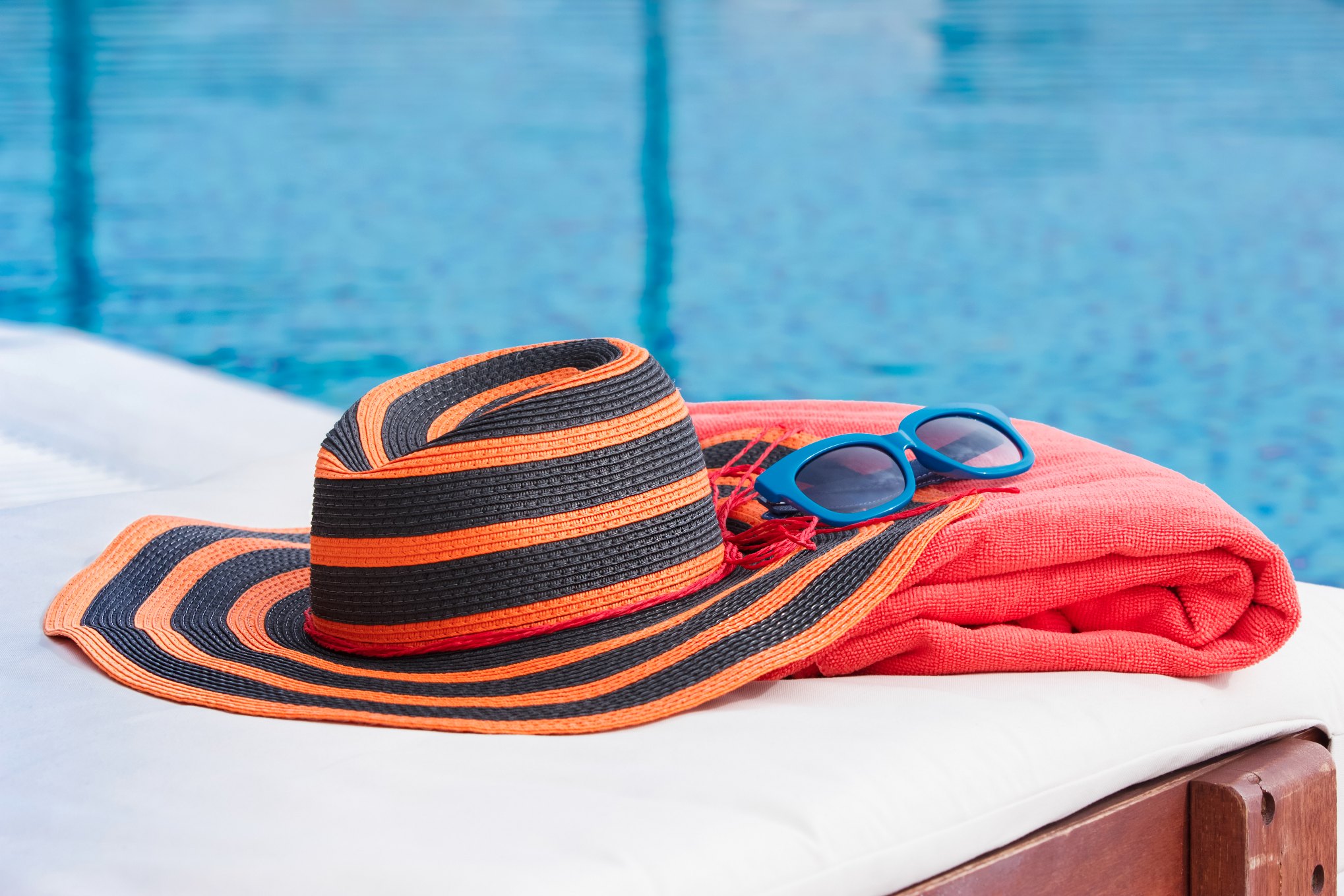 POOL SIDE WITH TOWEL AND A HAT