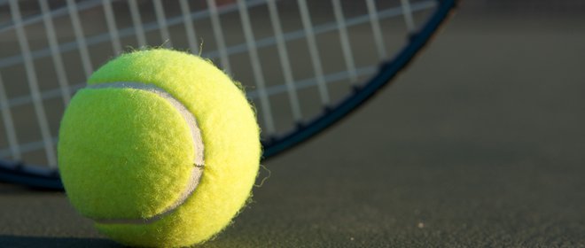 Tennis Ball with Racket in the background